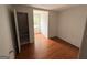 Bedroom featuring hardwood floors, white walls, and a closet at 305 Anderson Cir, Covington, GA 30016