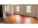 Bedroom featuring hardwood floors, white walls, and two windows at 305 Anderson Cir, Covington, GA 30016