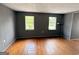 Bedroom features gray walls, hardwood floors, and natural light from two windows at 305 Anderson Cir, Covington, GA 30016
