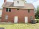 Back of the brick house with two entry doors at 305 Anderson Cir, Covington, GA 30016
