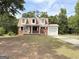 Charming brick home featuring dormer windows and an attached single car garage at 305 Anderson Cir, Covington, GA 30016