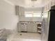 Bright kitchen featuring modern appliances, light grey cabinets, and stainless steel refrigerator at 305 Anderson Cir, Covington, GA 30016
