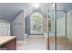Bathroom featuring tiled shower and tub, an arched window, and neutral walls and flooring at 465 Willowbrook Dr, Smyrna, GA 30082