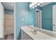 Bathroom featuring a single sink vanity, large mirror, shower/tub combo, and light blue walls at 465 Willowbrook Dr, Smyrna, GA 30082