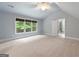 Spacious bedroom with neutral walls, a ceiling fan, and a view of the outdoors through a large window at 465 Willowbrook Dr, Smyrna, GA 30082