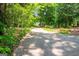 View of the driveway winding through trees and landscaping at 465 Willowbrook Dr, Smyrna, GA 30082