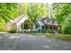 Beautiful two-story home with lush landscaping, mature trees, and a welcoming front porch at 465 Willowbrook Dr, Smyrna, GA 30082