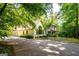 View of the home's exterior with ample parking and mature trees at 465 Willowbrook Dr, Smyrna, GA 30082