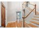 Inviting foyer with hardwood floors, staircase, and French doors leading to other rooms at 465 Willowbrook Dr, Smyrna, GA 30082