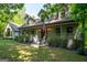 Charming home with covered porch, American flag, and mature trees set on a well-manicured lawn at 465 Willowbrook Dr, Smyrna, GA 30082