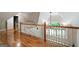 Hallway featuring shiny hardwood floors, wooden railings, and natural light from an arched window at 465 Willowbrook Dr, Smyrna, GA 30082