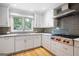 Bright kitchen with gray tile backsplash, stainless appliances and lots of natural light at 465 Willowbrook Dr, Smyrna, GA 30082
