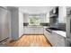 Well-appointed kitchen with white cabinetry, stainless steel appliances, and hardwood floors at 465 Willowbrook Dr, Smyrna, GA 30082