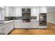 Modern kitchen with stainless steel appliances, white cabinets, and granite countertops at 465 Willowbrook Dr, Smyrna, GA 30082