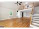 Bright living room featuring hardwood floors, vaulted ceiling, and a loft with railing at 465 Willowbrook Dr, Smyrna, GA 30082
