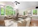 Bright living room features a soaring vaulted ceiling and large windows offering scenic views of the property at 465 Willowbrook Dr, Smyrna, GA 30082
