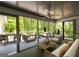 Covered porch features comfortable seating, ceiling fan and views of mature trees and lush landscaping at 465 Willowbrook Dr, Smyrna, GA 30082