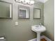 Traditional powder room with pedestal sink, decorative mirrors, and accent lighting at 465 Willowbrook Dr, Smyrna, GA 30082
