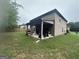Large backyard with green grass and covered patio, perfect for outdoor activities and entertainment at 7644 Wrotham Cir, South Fulton, GA 30349