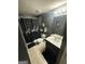 Cozy bathroom features a shower with decorative black curtain, a pedestal sink, and modern fixtures at 7644 Wrotham Cir, South Fulton, GA 30349