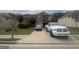 Two-story home with brick facade, manicured lawn, and ample parking space at 7644 Wrotham Cir, South Fulton, GA 30349