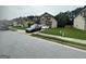 View of the side of this two-story home, showing the lawn and the private driveway that leads to an attached garage at 7644 Wrotham Cir, South Fulton, GA 30349
