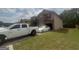 Side view of a two-story home with a driveway, lawn, and attached garage at 7644 Wrotham Cir, South Fulton, GA 30349
