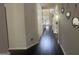 Hallway with dark hardwood floors and decorative wall mirrors at 7644 Wrotham Cir, South Fulton, GA 30349