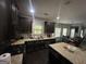 Eat-in kitchen with stainless steel appliances, dark wood cabinets and granite countertops, perfect for modern living at 7644 Wrotham Cir, South Fulton, GA 30349
