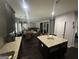 Open-concept kitchen with an island, dark wood cabinets, granite countertops, and stainless steel appliances at 7644 Wrotham Cir, South Fulton, GA 30349