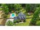 Aerial view of a traditional home with a large lot, mature trees, a pool, and outdoor entertainment area at 171 Ponderosa Drive, Fayetteville, GA 30214