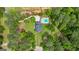 Expansive aerial view of estate home featuring a private pool surrounded by lush, mature landscaping, and a manicured lawn at 171 Ponderosa Drive, Fayetteville, GA 30214