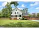 Spacious backyard featuring a well-maintained lawn with an in-ground pool and a charming back porch at 171 Ponderosa Drive, Fayetteville, GA 30214