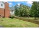 Backyard view of home with mature trees, a gazebo, and playground equipment at 171 Ponderosa Drive, Fayetteville, GA 30214