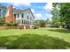 Spacious backyard featuring a well-maintained lawn with an in-ground pool and a charming gazebo at 171 Ponderosa Drive, Fayetteville, GA 30214