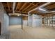 Unfinished basement with concrete floors, brick fireplace, and block walls at 171 Ponderosa Drive, Fayetteville, GA 30214