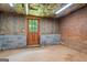 Basement with brick wall, concrete block foundation, and wooden door to outside at 171 Ponderosa Drive, Fayetteville, GA 30214