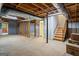 Unfinished basement with exposed wood, concrete floors, and door to outside at 171 Ponderosa Drive, Fayetteville, GA 30214