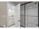 Bathroom featuring tub/shower with glass door, subway tile, and double sink vanity at 171 Ponderosa Drive, Fayetteville, GA 30214