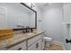 Elegant powder room featuring a granite countertop, modern sink, and a large mirror at 171 Ponderosa Drive, Fayetteville, GA 30214