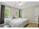 Cozy bedroom with two windows, ceiling fan, and warm paint tones for a welcoming atmosphere at 171 Ponderosa Drive, Fayetteville, GA 30214