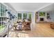 Open dining area with hardwood floors, a telescope, a rustic table, and open views into the living room at 171 Ponderosa Drive, Fayetteville, GA 30214