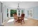 Bright dining area with a wood table, chandelier, and large windows looking out to the yard at 171 Ponderosa Drive, Fayetteville, GA 30214