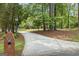 Long driveway through wooded lot leads to home with brick mailbox at 171 Ponderosa Drive, Fayetteville, GA 30214