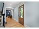 Charming foyer with hardwood floors, a wood door, and soft blue walls leading to a living space at 171 Ponderosa Drive, Fayetteville, GA 30214