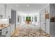 Open concept kitchen featuring a large island with granite countertops and views into the dining area at 171 Ponderosa Drive, Fayetteville, GA 30214