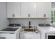 Laundry room featuring granite counters, basin sink, and white cabinets at 171 Ponderosa Drive, Fayetteville, GA 30214