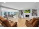 Spacious living room with hardwood floors, a fireplace, built-in shelves, and a view to the backyard at 171 Ponderosa Drive, Fayetteville, GA 30214