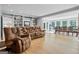 Open concept living room with hardwood floors, a large seating area, built-in bookshelves, and bright, natural light at 171 Ponderosa Drive, Fayetteville, GA 30214