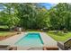 Backyard featuring large inground pool, brick patio, and play set at 171 Ponderosa Drive, Fayetteville, GA 30214